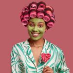 "a thumbnail picture of a black woman with hair rollers"